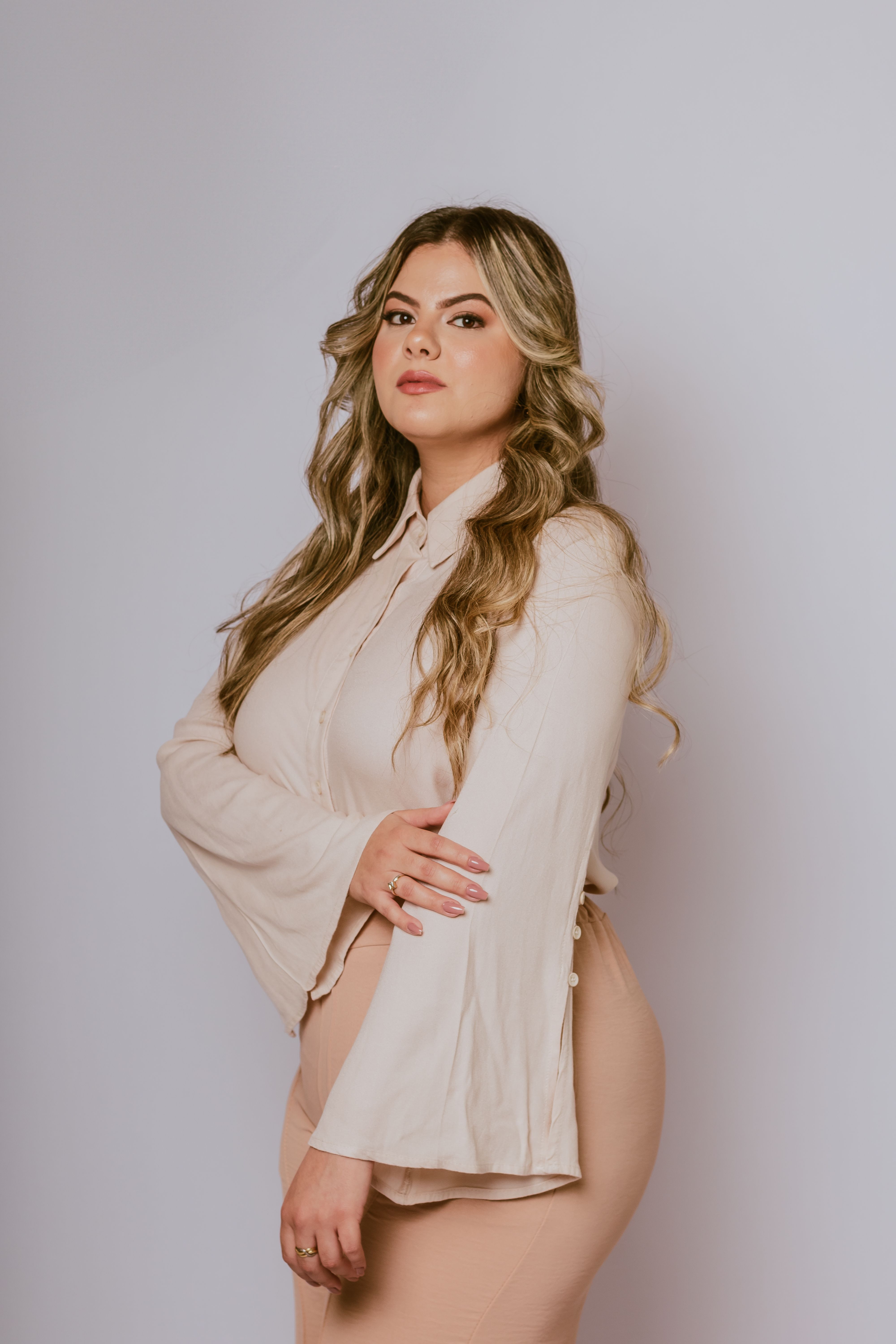Chic portrait of a confident young woman with long hair, showcasing fashion and style.