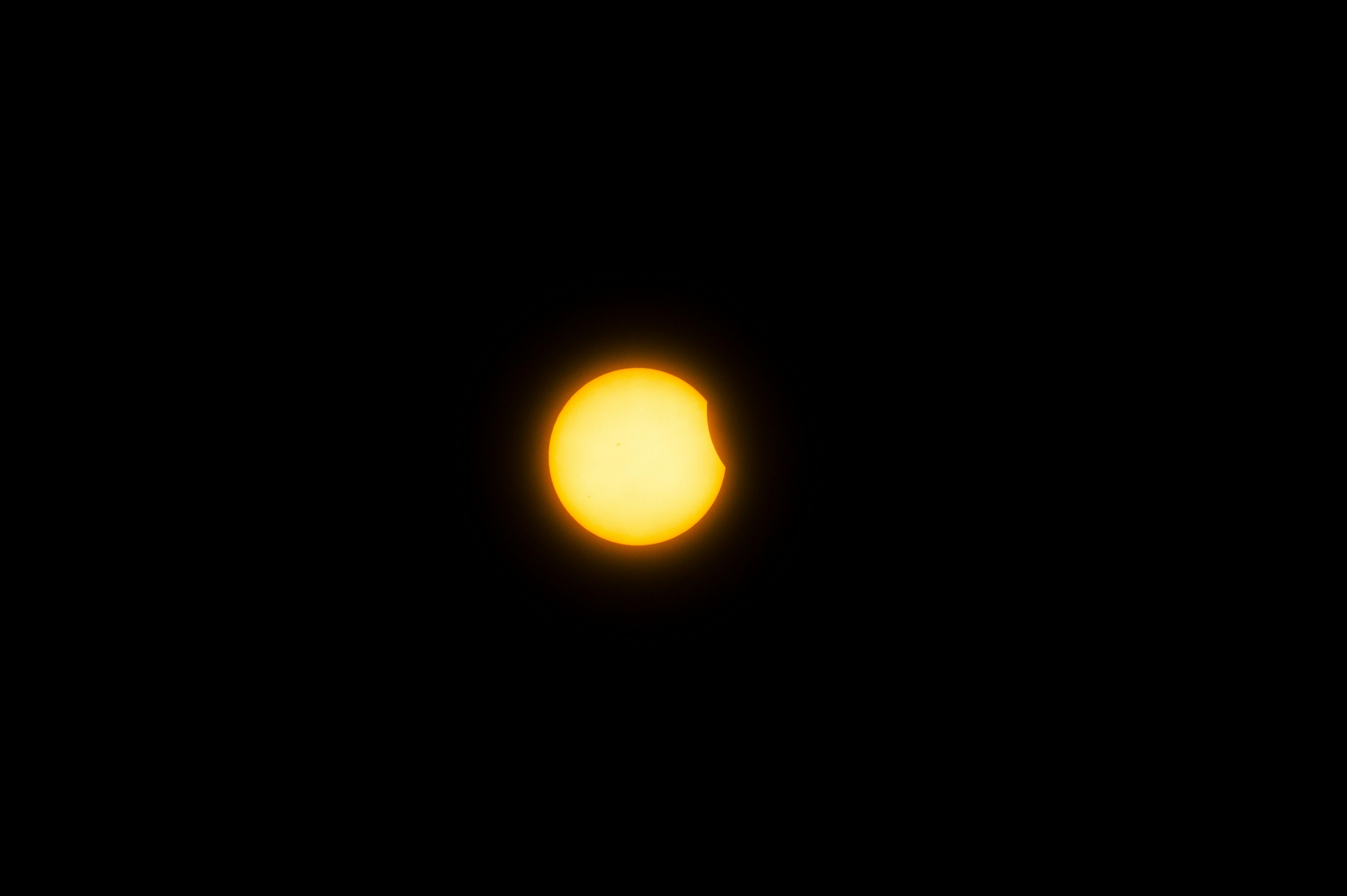 a bright yellow sun is seen in the dark