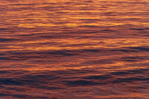 Free Stunning golden sunset reflecting on ocean waves in Mazatlán, México, creating a vibrant and serene seascape. Stock Photo