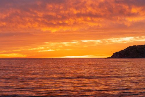 Free Breathtaking sunset in Mazatlán, Mexico with vibrant orange sky reflecting on tranquil ocean waters. Stock Photo