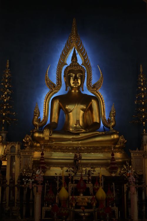 Free Majestic golden Buddha statue in a richly adorned shrine with intricate details. Stock Photo