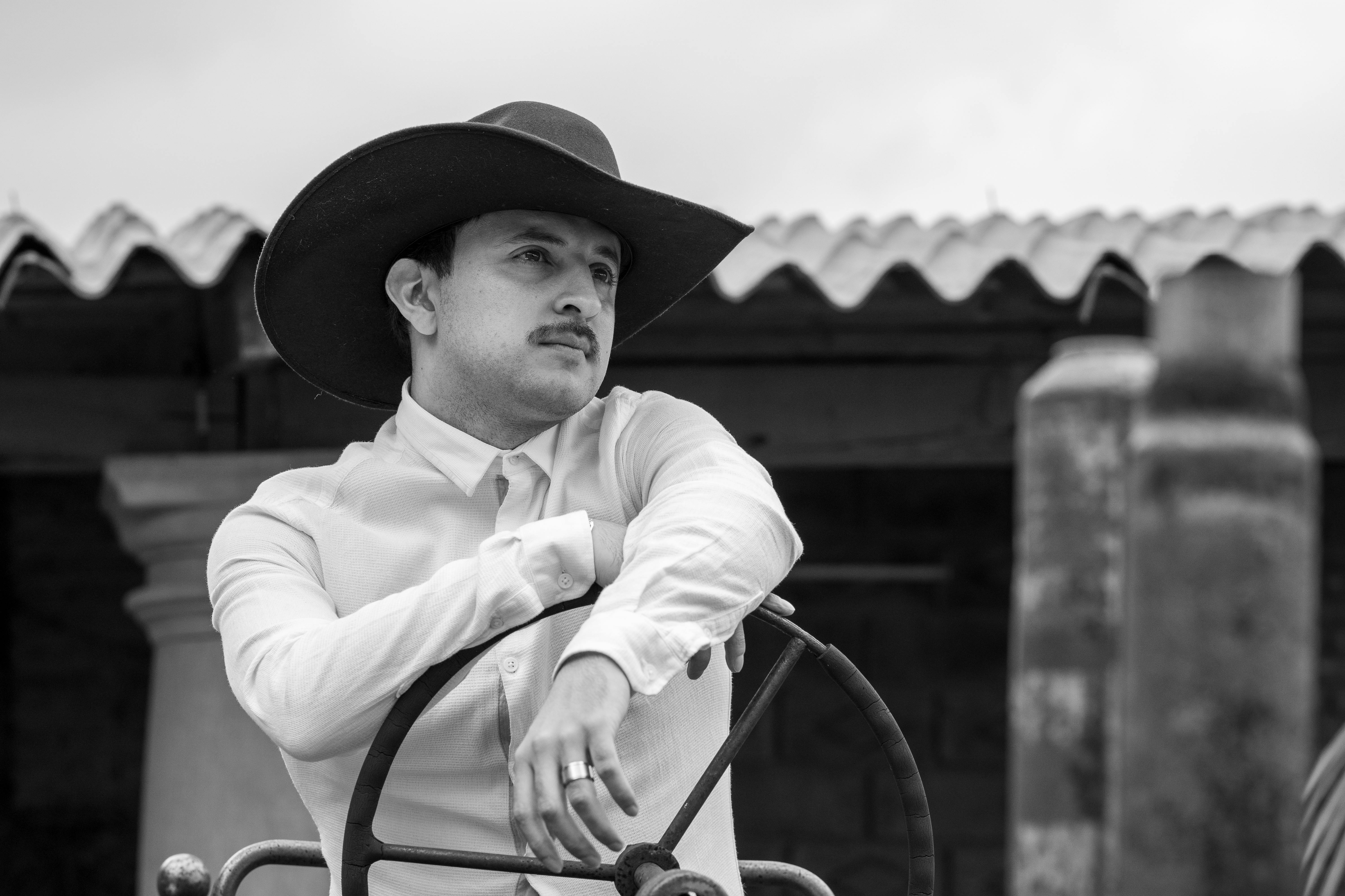 a man in a cowboy hat sitting on a tractor