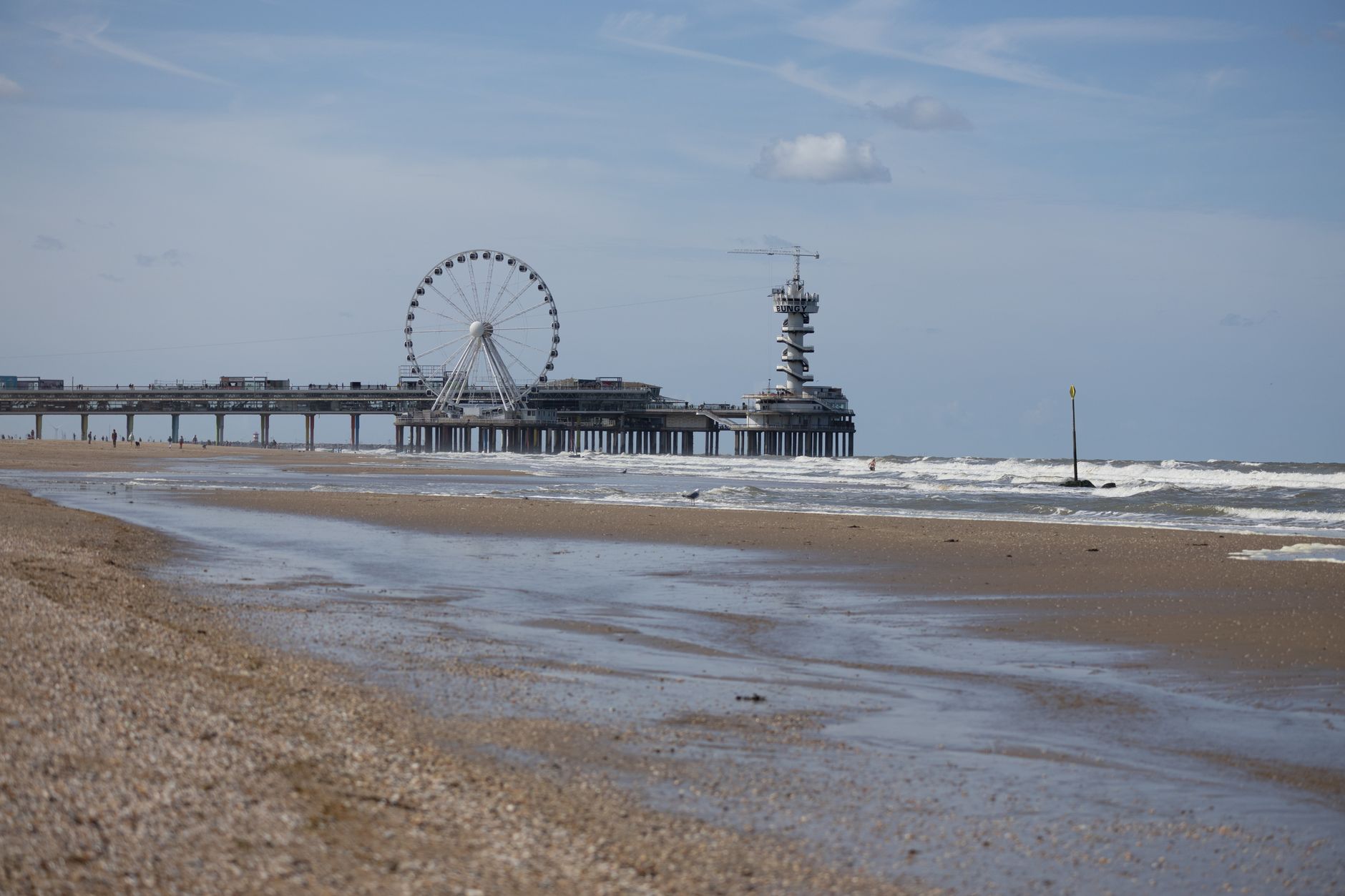 Enjoy the sunny beach views of The Hague with the iconic Pier and Ferris wheel against the North Sea waves.