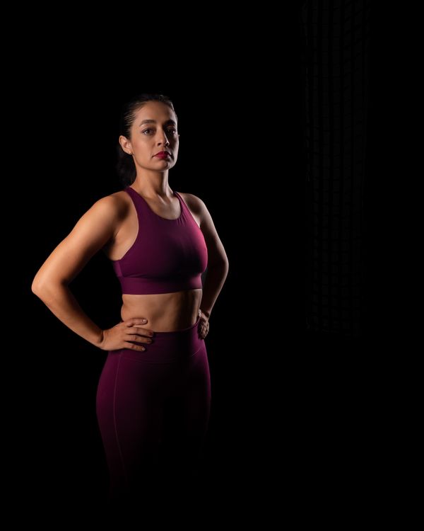 Athlete in training kit against a dark studio backdrop, photo by Jimmy Elizarraras on Pexels