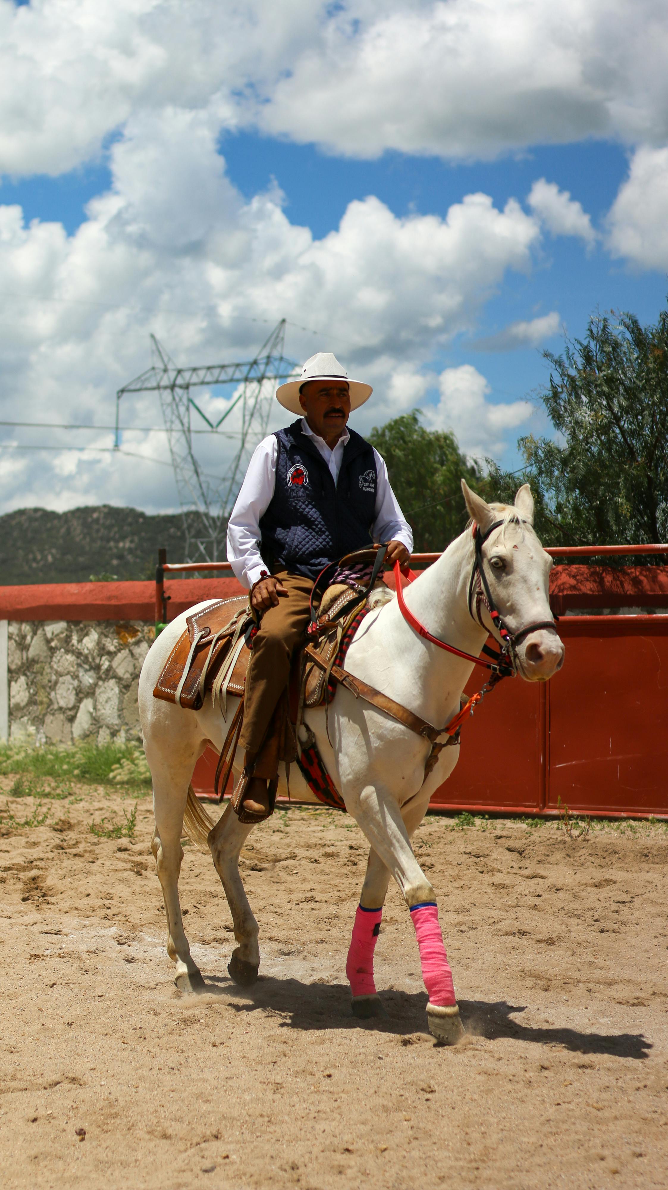 A traditional horseman rides during a cultural event, showcasing Mexican heritage.