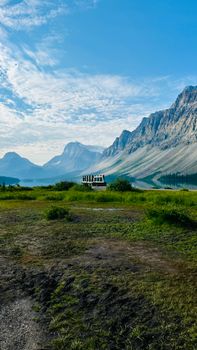 Tranquil summer landscape featuring mountains, a serene lake, and lush greenery.