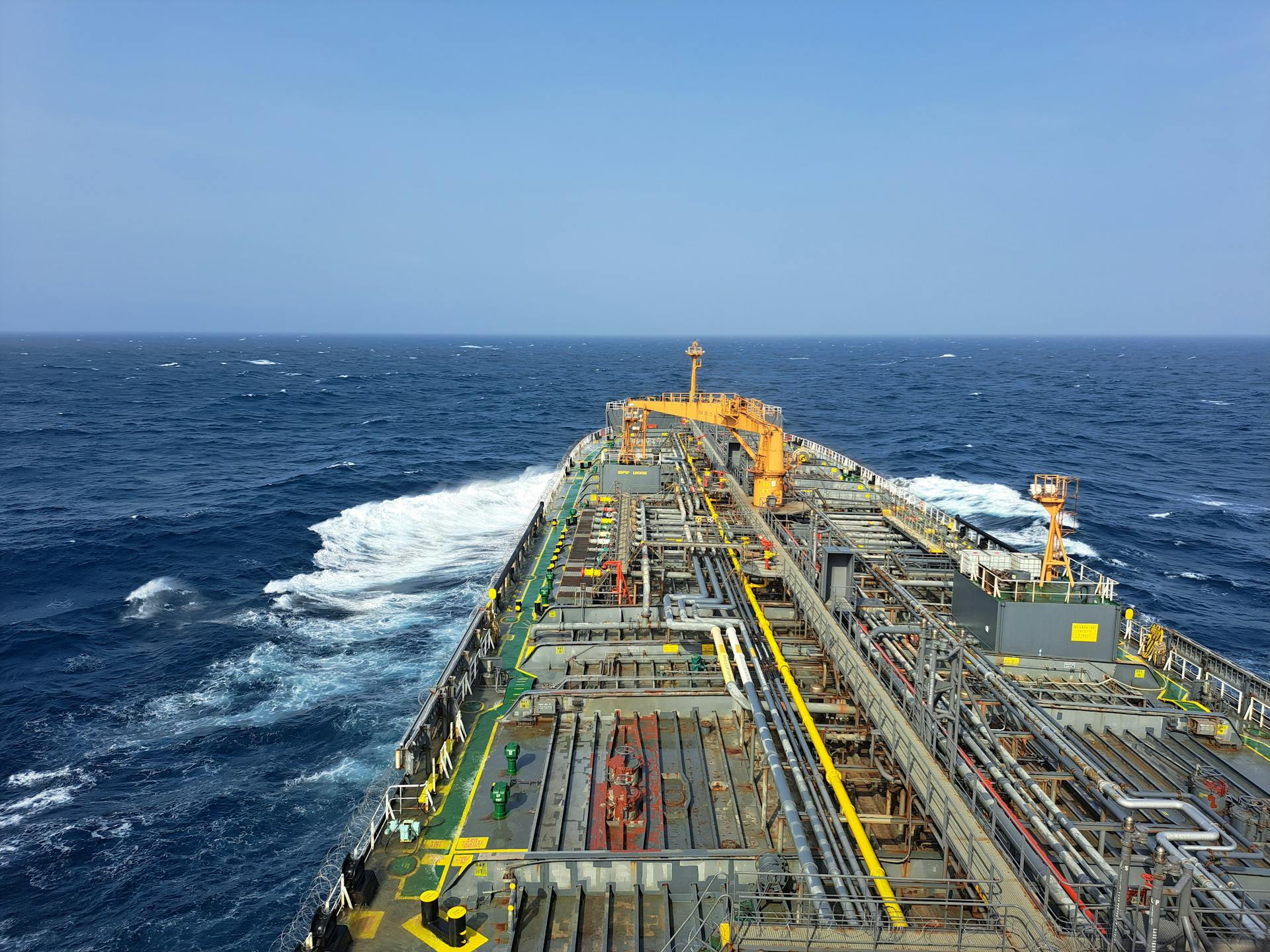 Aerial view of a large industrial ship navigating the open ocean, showcasing heavy industry transportation.