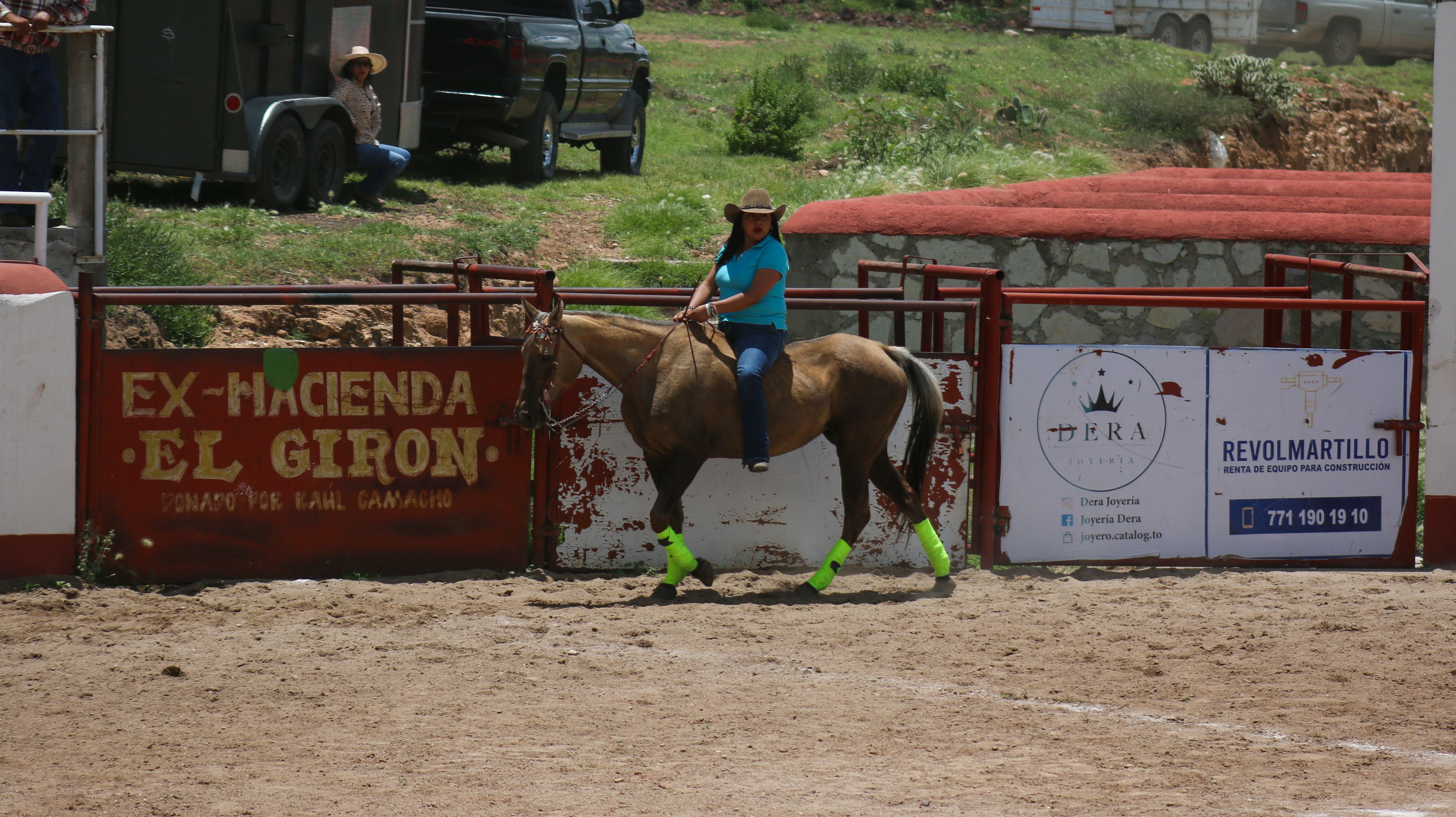 Woman on horseback at Ex-Hacienda El Giron, vibrant equestrian scene in outdoor arena.