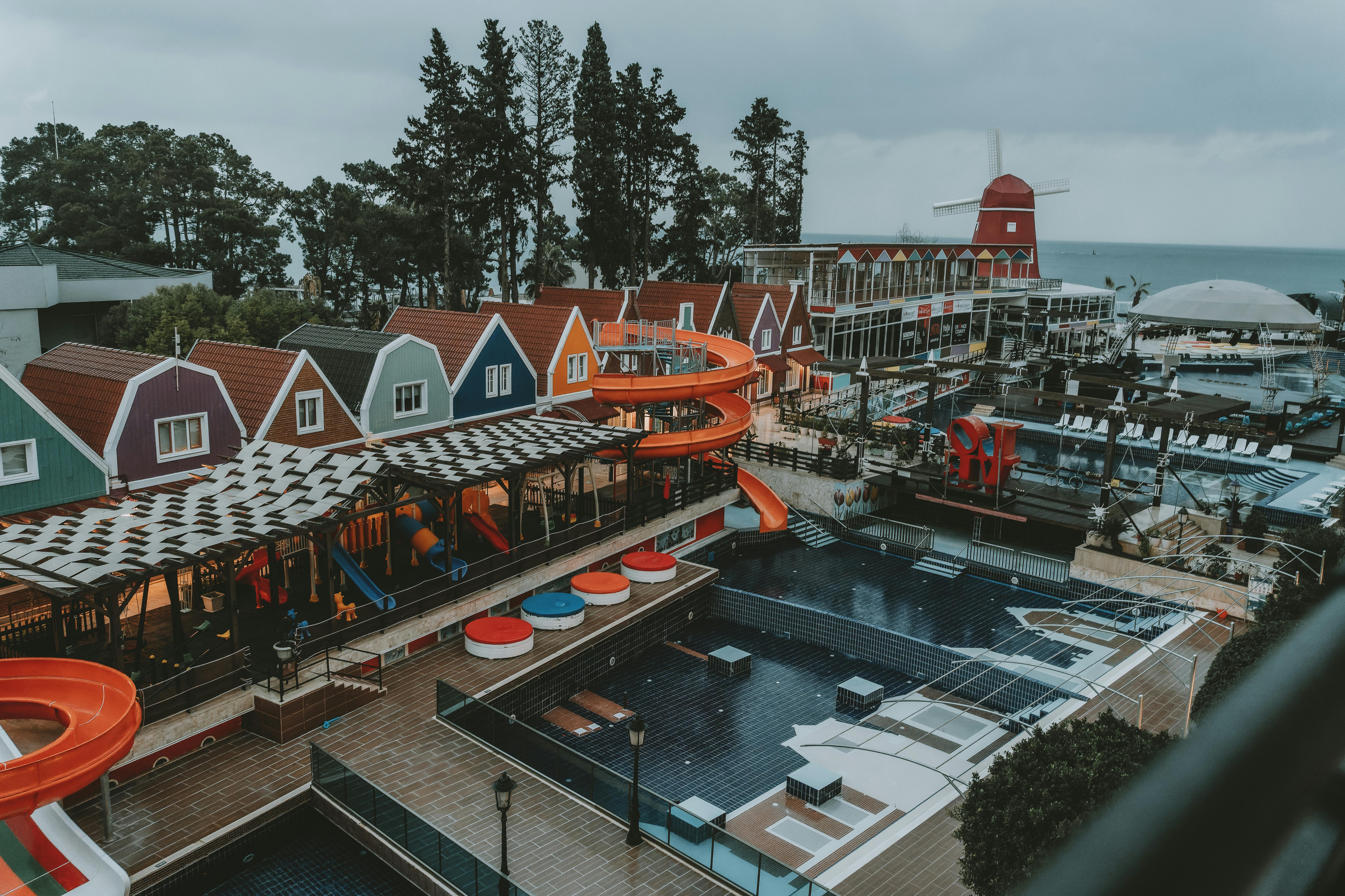 A colorful coastal resort in Antalya, Turkey with vibrant buildings and water slides.