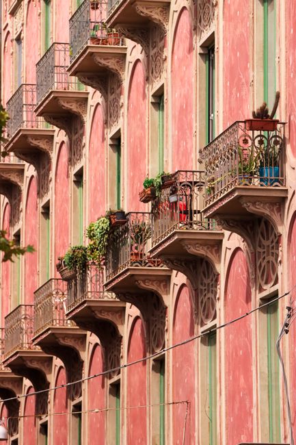 Vibrant balconies on a historic building in Catania, Sicily, showcasing traditional Italian architecture.