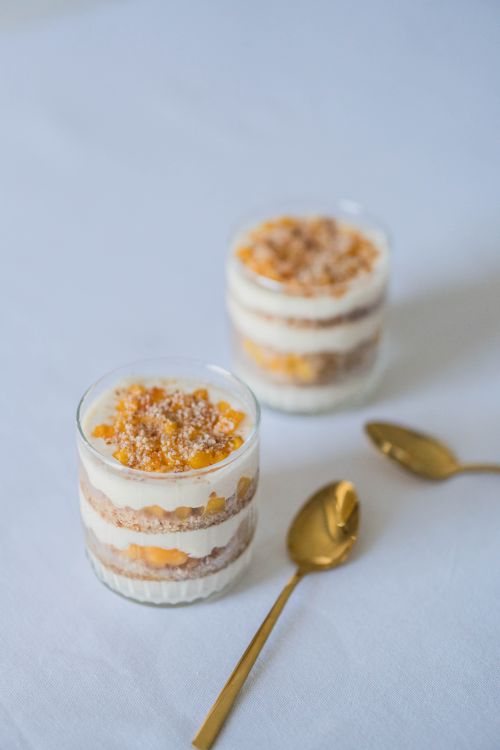 Free Layered dessert with cream and caramel in glass jars, perfect for a sweet treat. Stock Photo