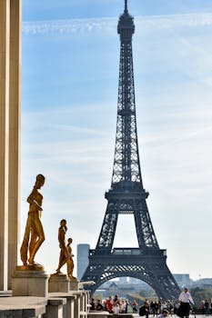 Captivating image of the Eiffel Tower from Trocadéro with golden statues in foreground.