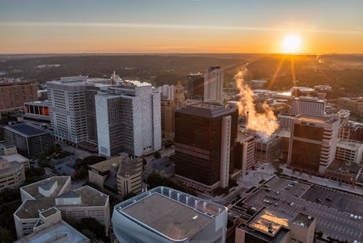 Stunning aerial sunrise view of Rochester, MN skyline with urban architecture and vibrant colors.