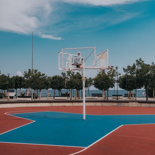 Free Vibrant basketball court by the seafront in Antalya, Turkey. Perfect for outdoor sports activities. Stock Photo