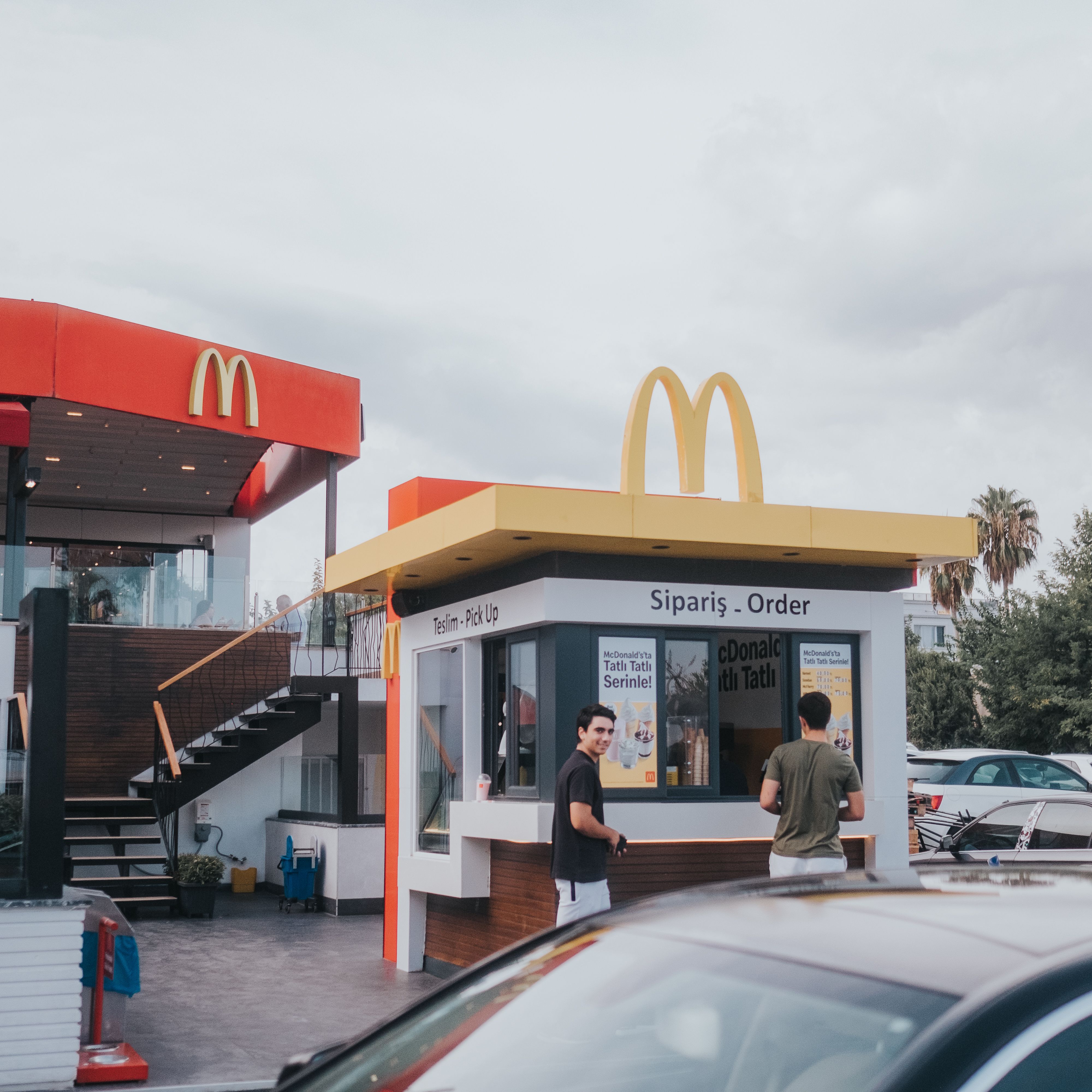 Men Standing near McDonalds Restaurant