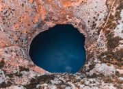 Close-up Photography of Hole and Body of Water