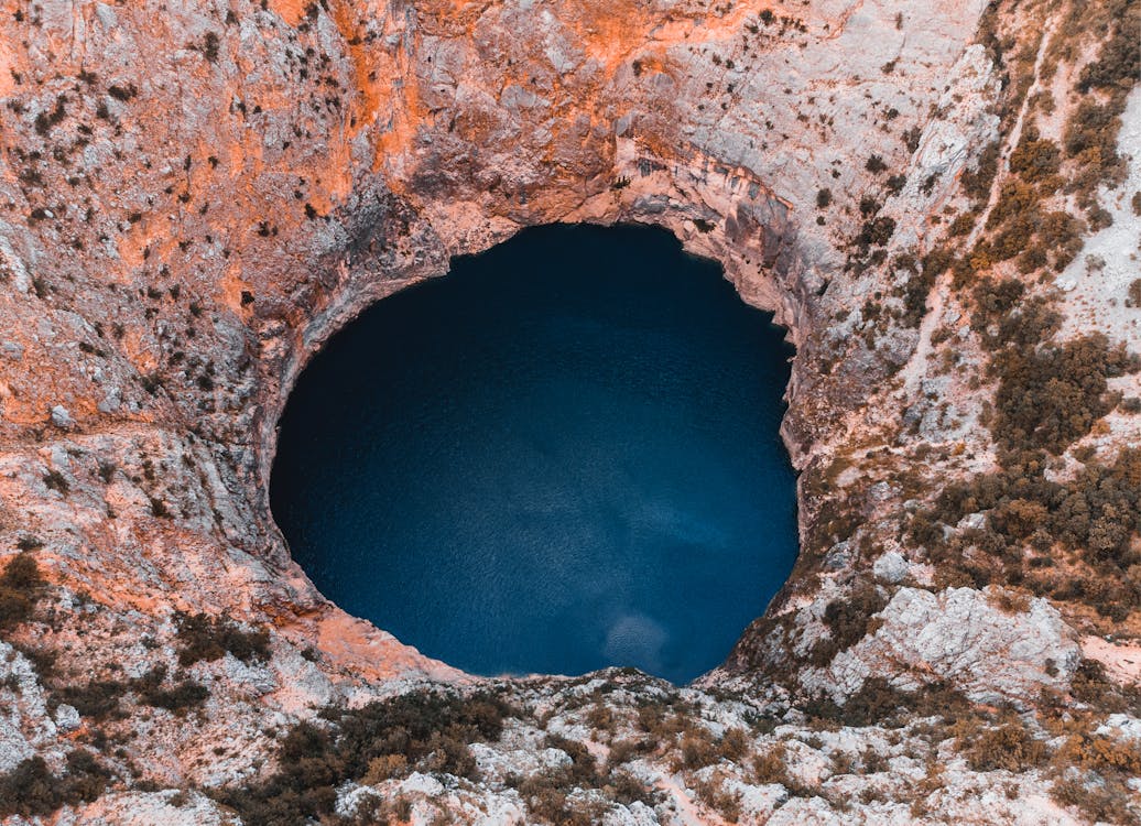 Close-up Photography of Hole and Body of Water