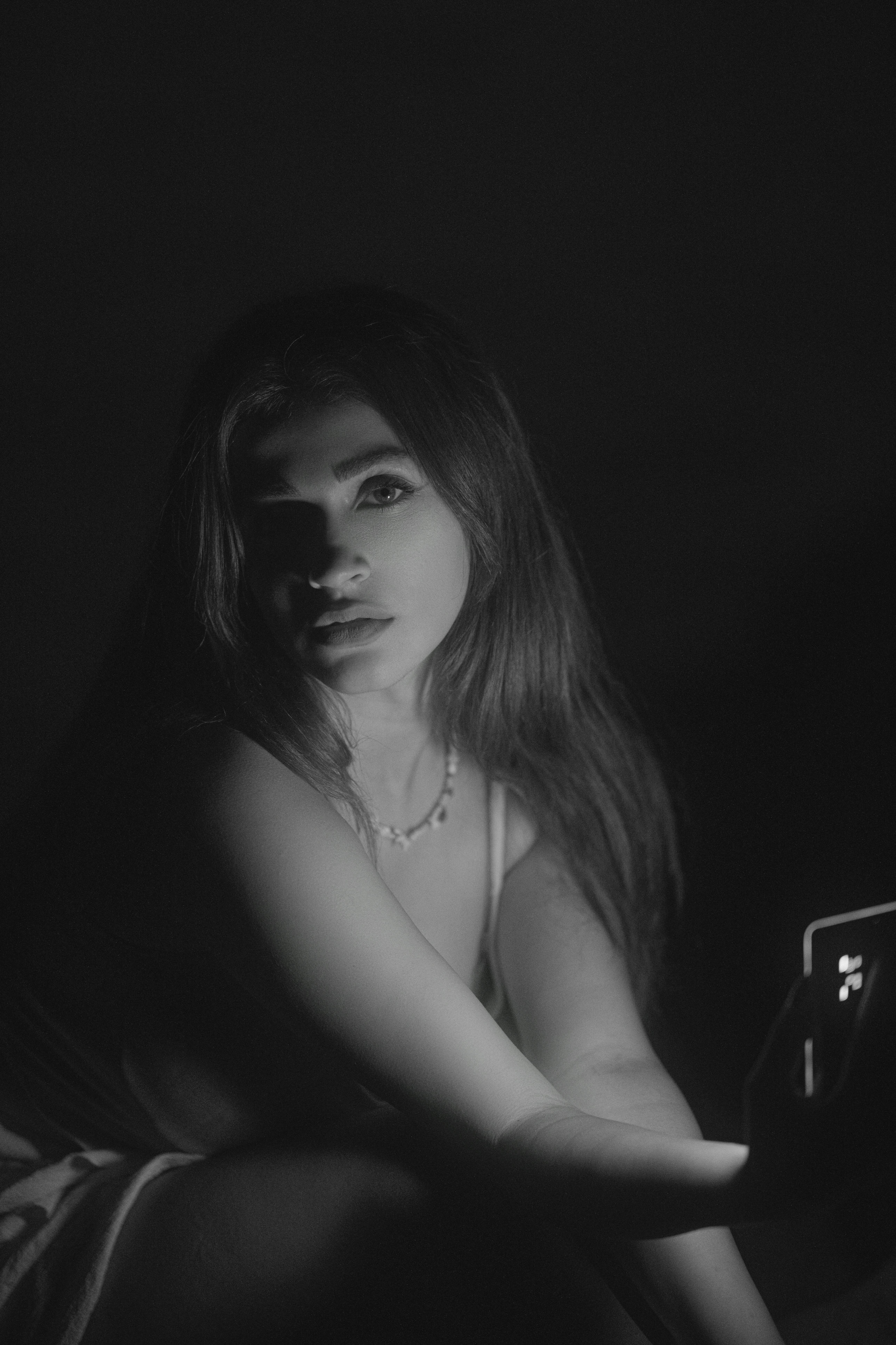 Glamorous black and white portrait of a woman with dramatic lighting.