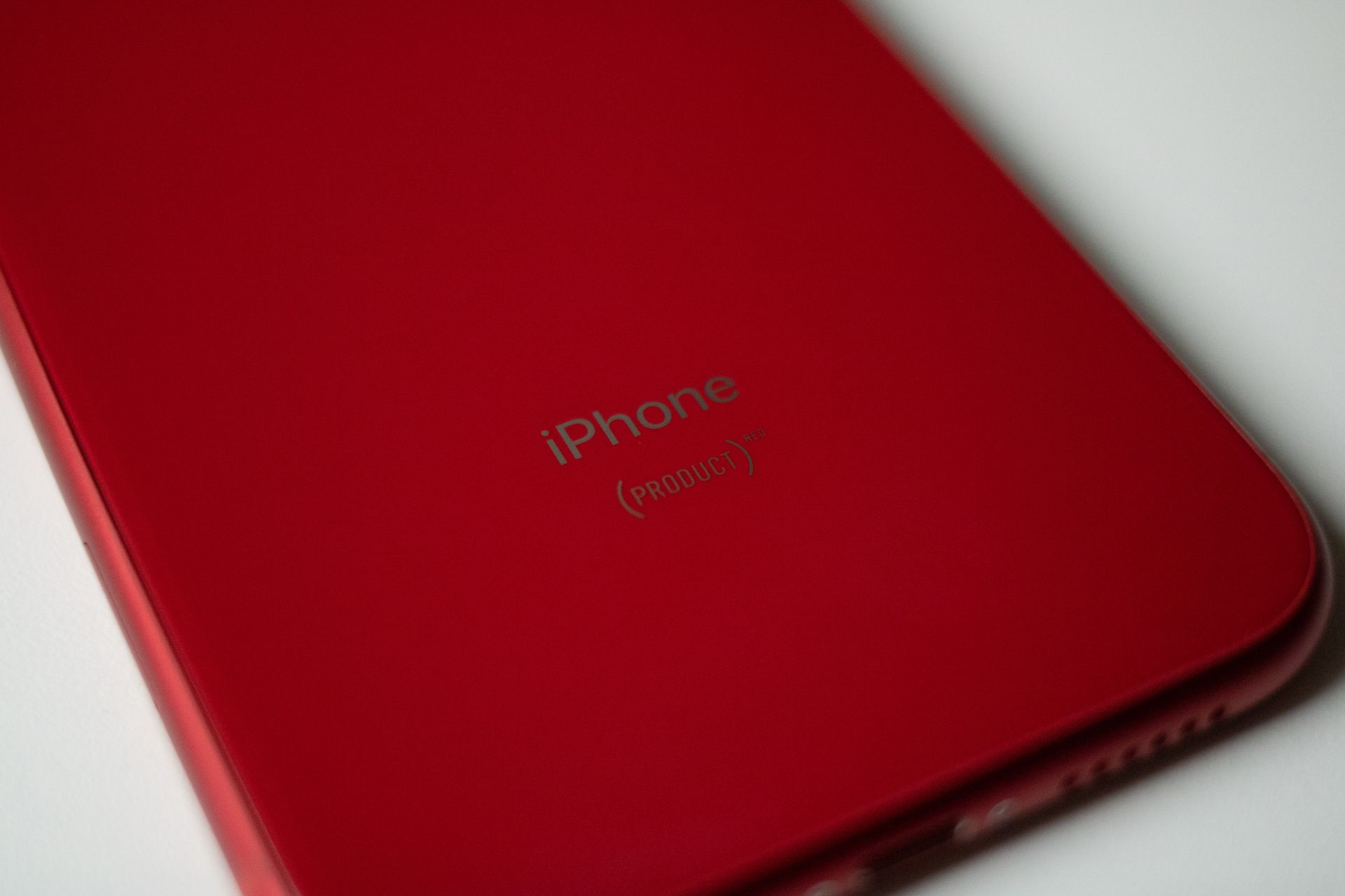 Elegant close-up of a sleek red smartphone design, highlighting contours and color.