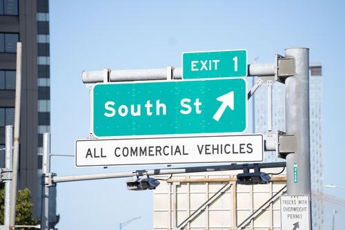 Free Green street sign for South Street and exit 1, directing all commercial vehicles. Stock Photo