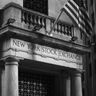 Black and white architectural photograph of the New York Stock Exchange facade and columns.