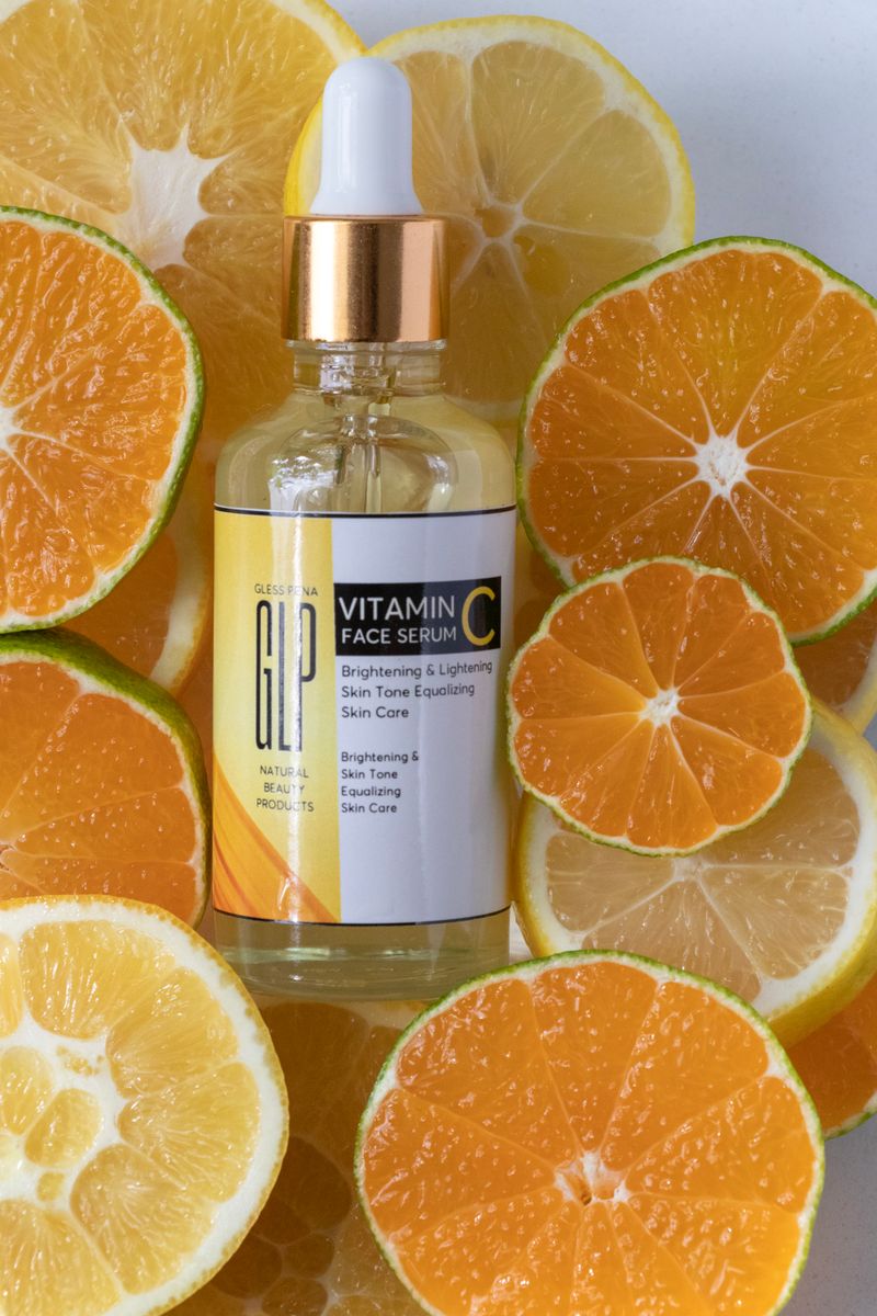 Vitamin C serum bottle surrounded by sliced citrus