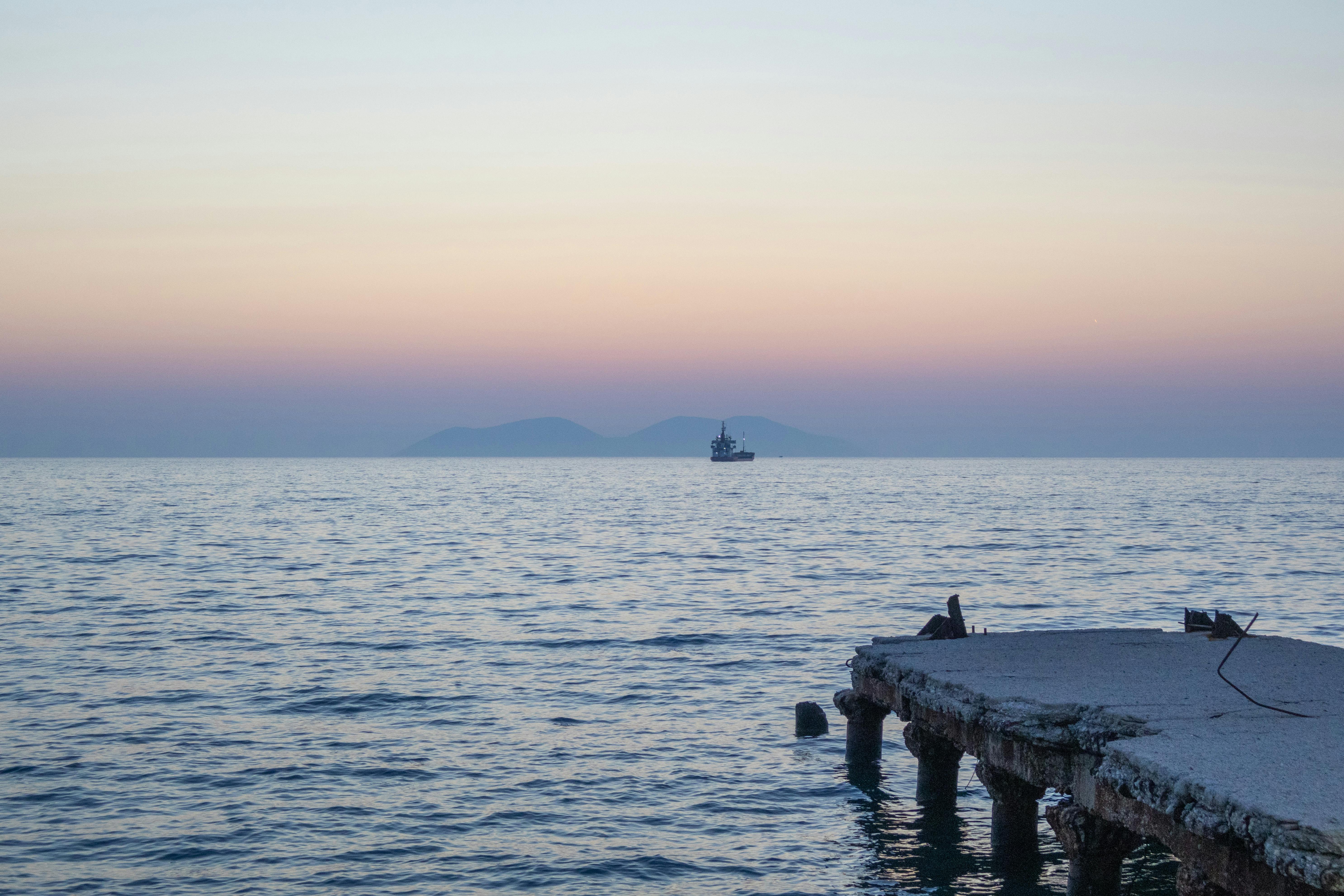 a pier with a boat in the distance