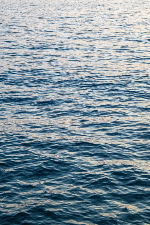 Free Serene view of ocean waves during sunset in Vlora, Albania, perfect for backgrounds. Stock Photo