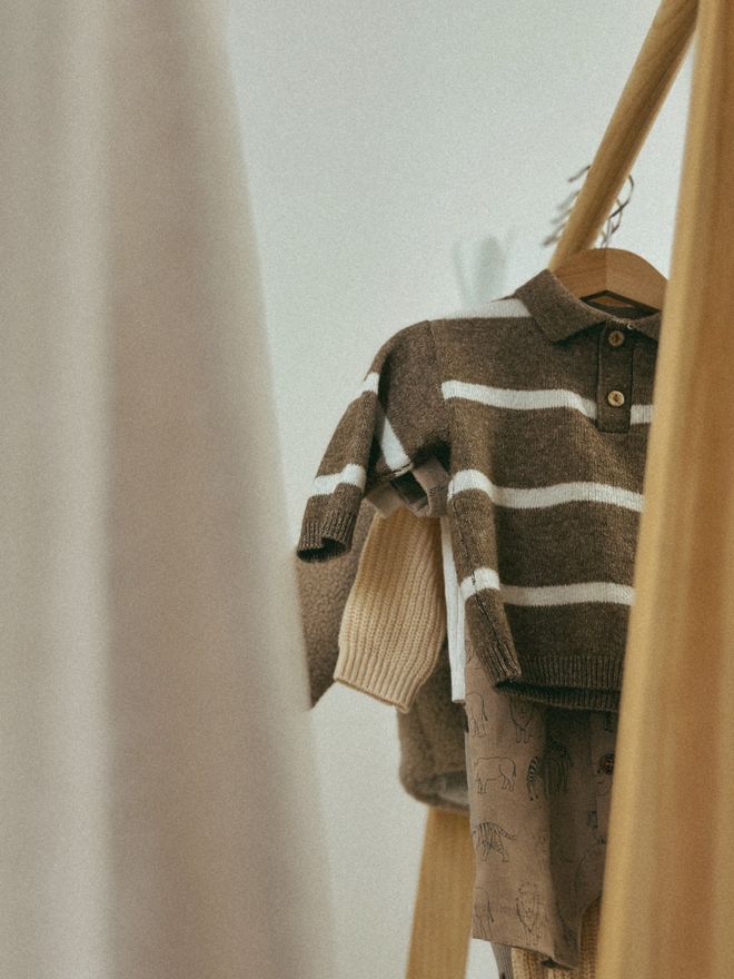Children's knitted long-sleeve top hanging on a rail — photo by Ruxanda Photography on Pexels