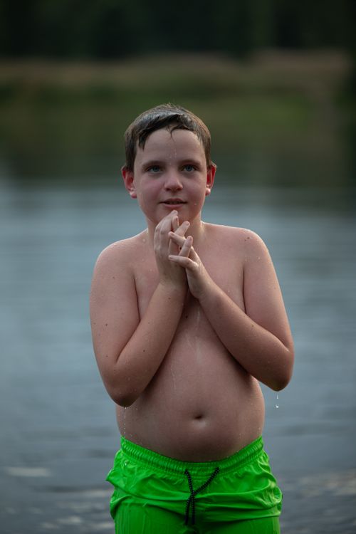 Free A young boy enjoying a refreshing swim on a sunny summer day at the lake. Stock Photo