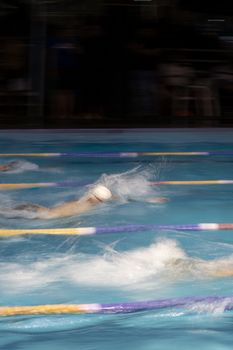Exciting swimming race action captured in San Luis Potosí, showcasing vibrant movement and dynamic water splashes.