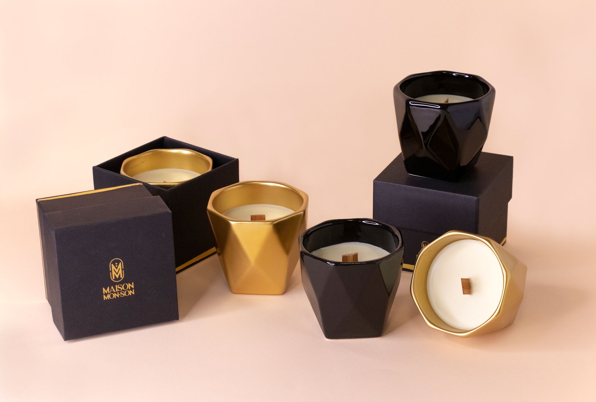 Luxurious black and gold candles in decorative holders, perfect for home decor.