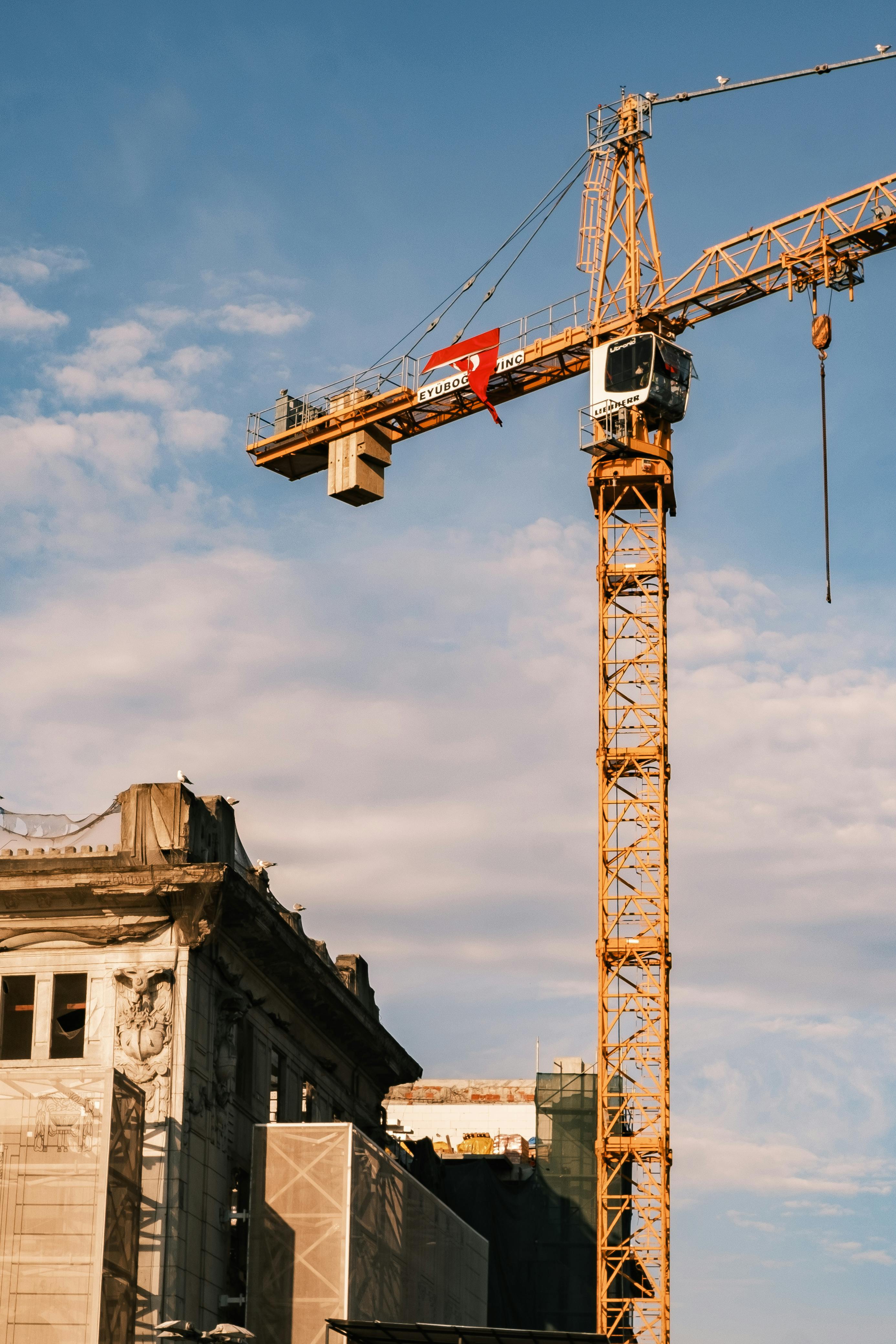 Tower Cranes Under Cloudy Sky · Free Stock Photo