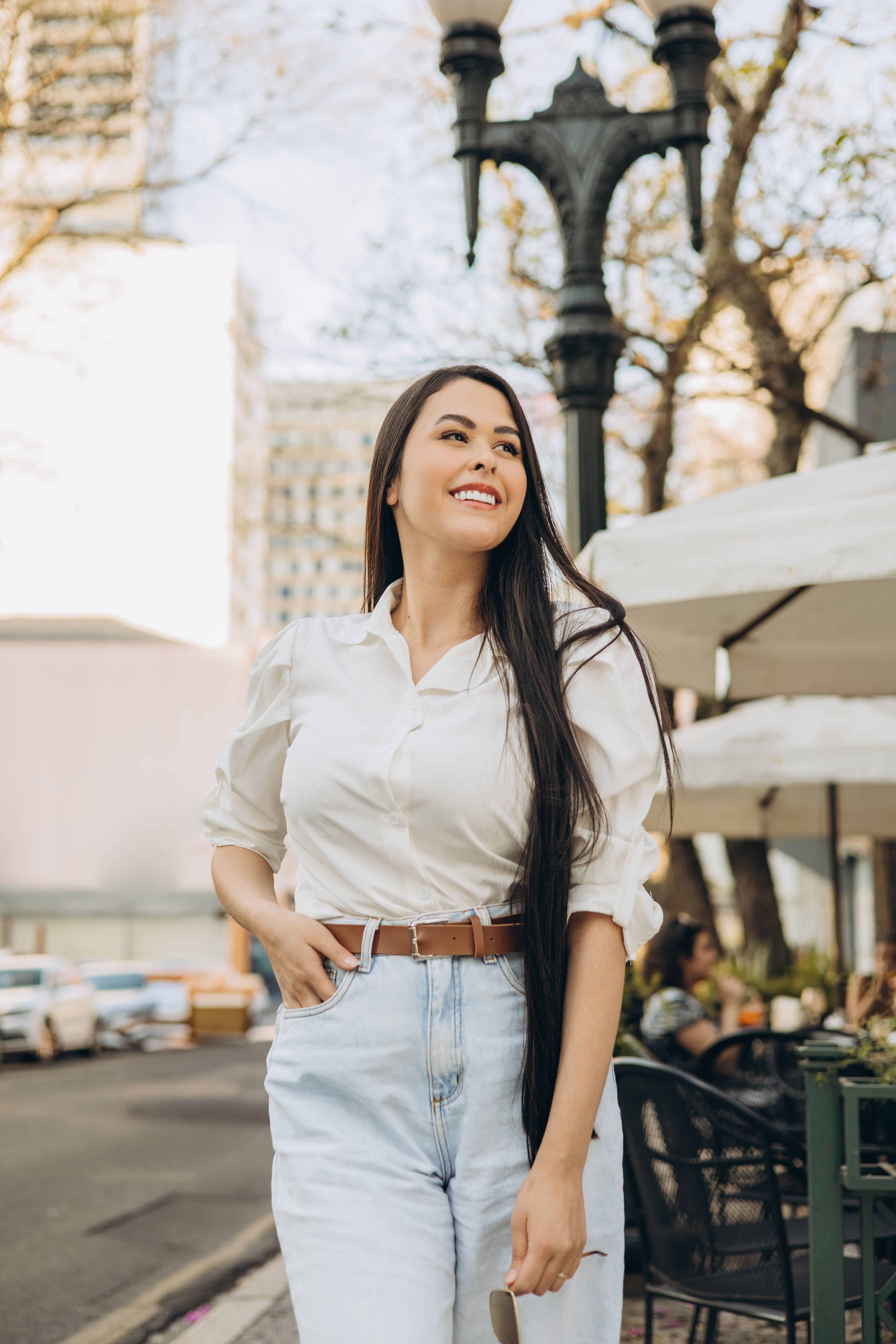 Woman in silk blouse with high waist jeans