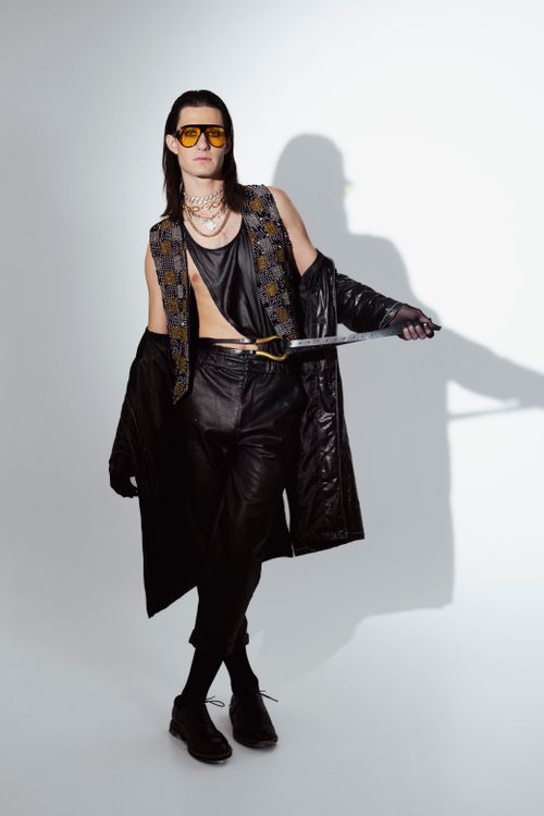 Free Fashion model in edgy attire posing in a studio with chic accessories. Stock Photo