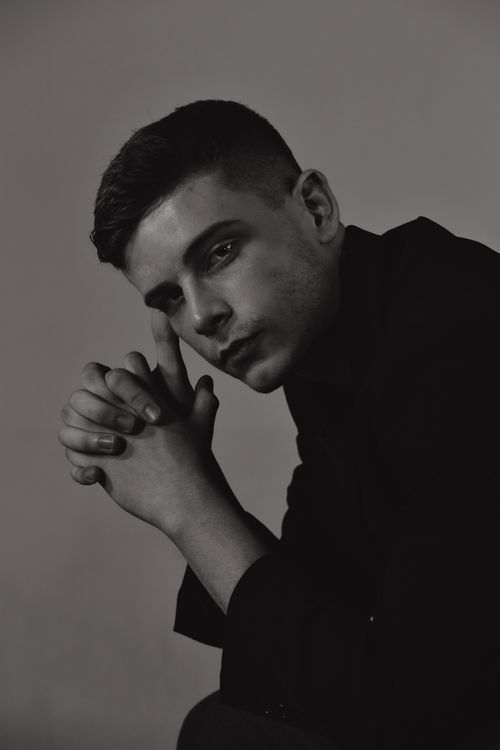 Free Moody black and white portrait of a man deep in thought, shot in a studio. Stock Photo