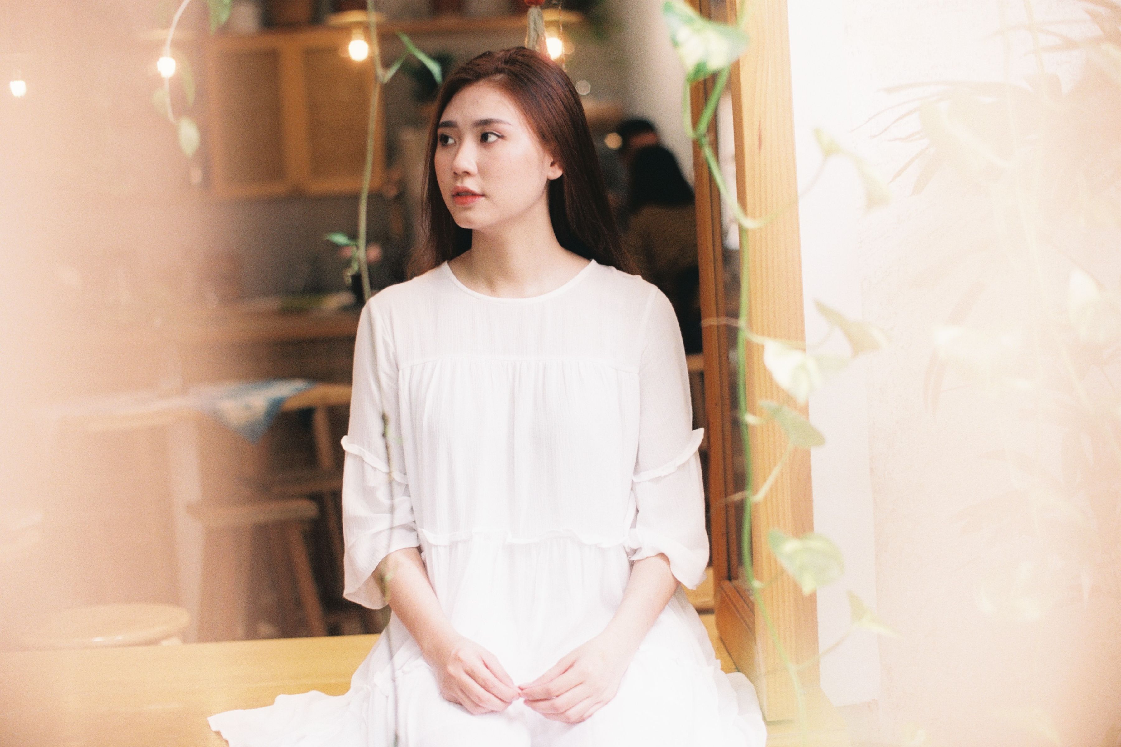 A woman in white dress sitting on a bench · Free Stock Photo