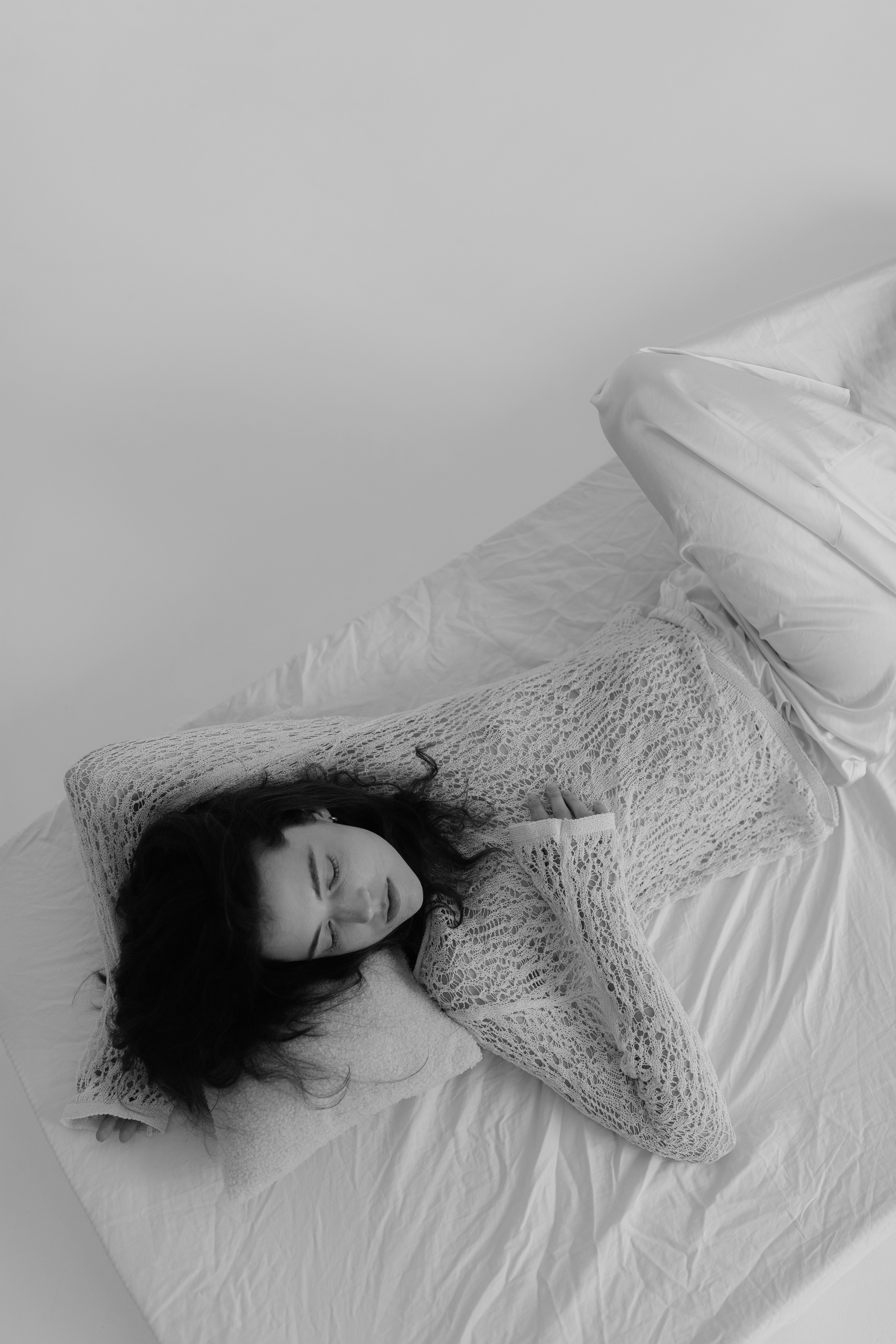 Black and White Studio Shot of a Young Woman Lying on a Bed · Free ...