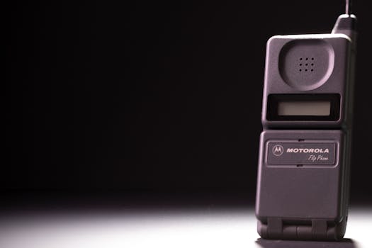 Classic Motorola flip phone on a dark background, highlighting its retro charm.