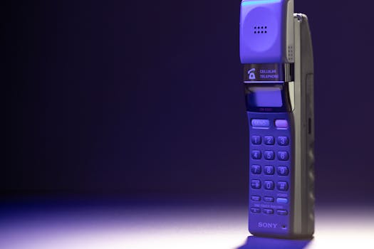 Close-up of a vintage 1990s cellular telephone in dramatic lighting.