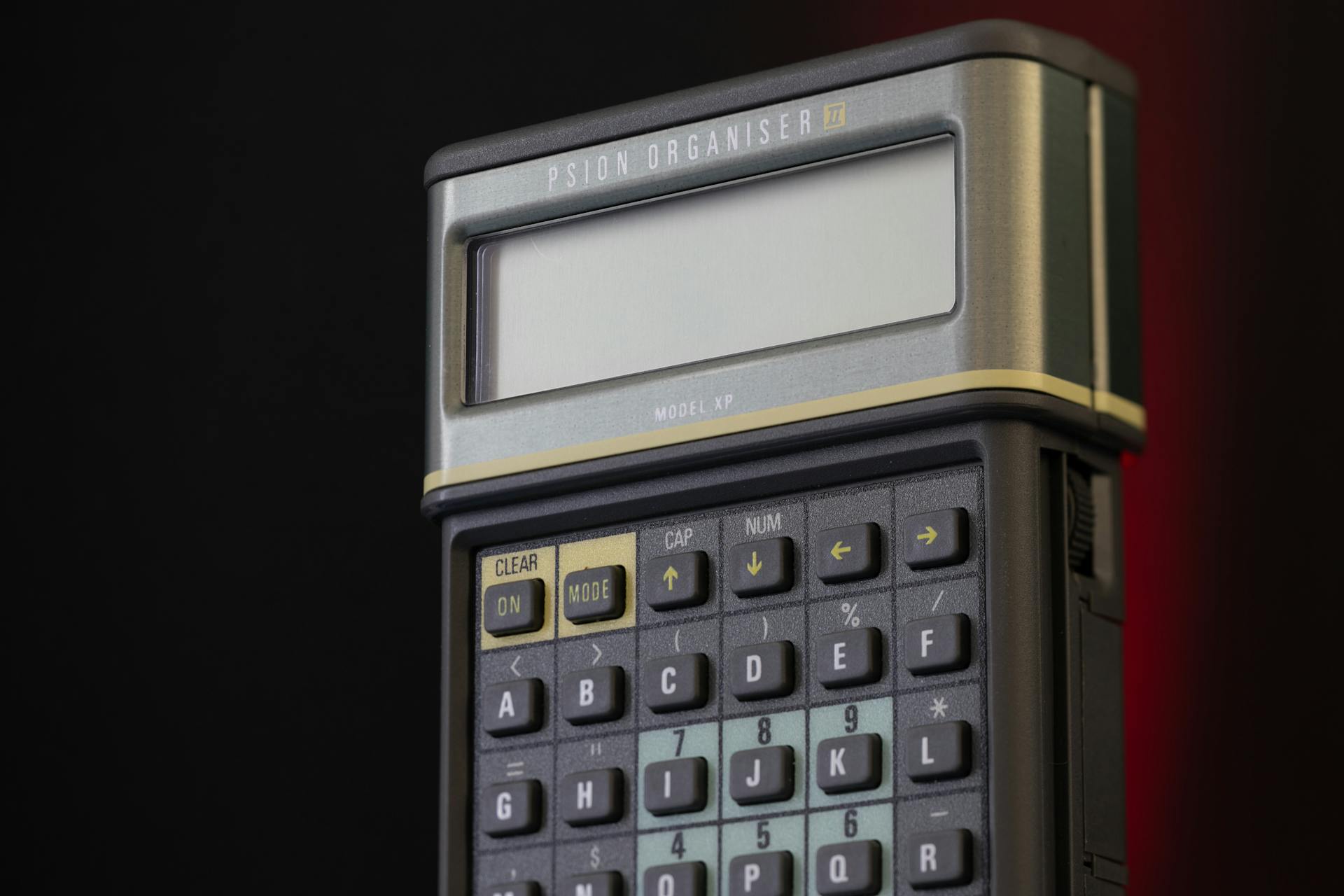 Close-up of a vintage Psion Organizer II Model XP showcasing its buttons and display screen.