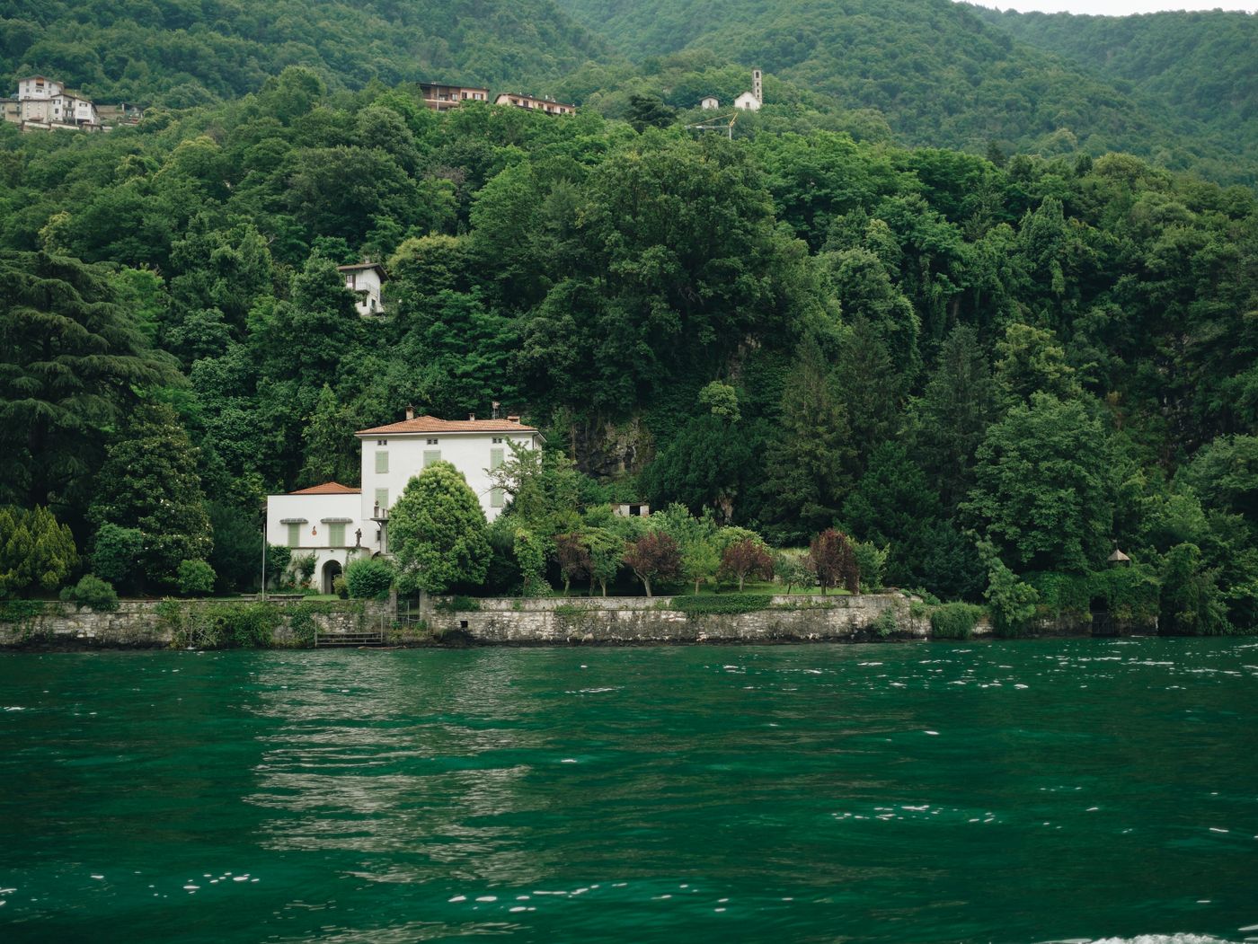 A villa among trees on the shore of Lake Como