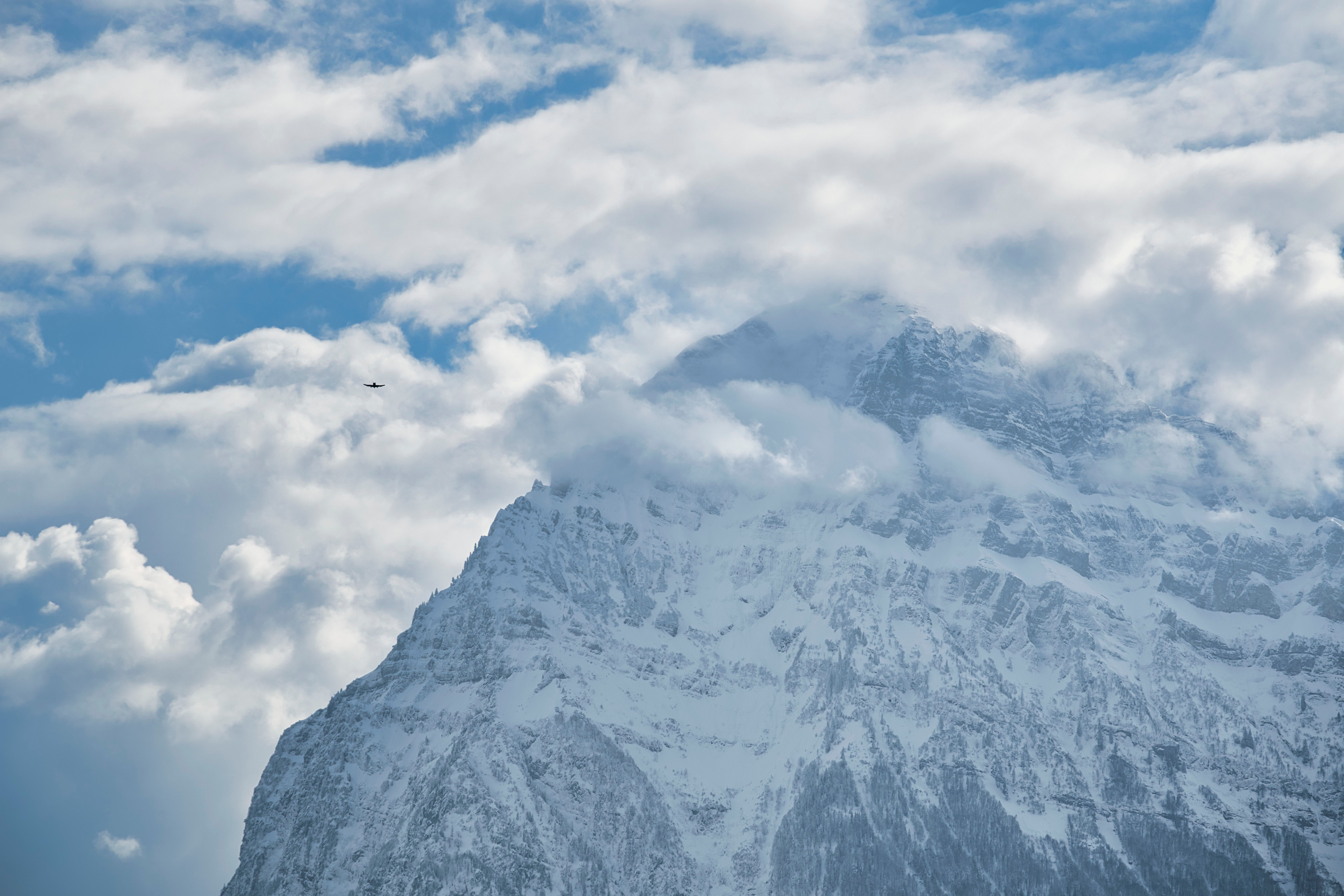 Snowy Mountain Peaks Under Cloudy Blue Sky · Free Stock Photo