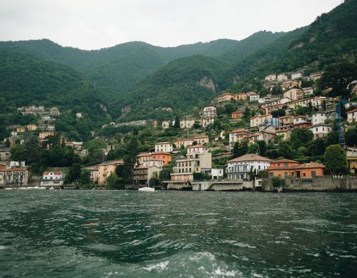 Free Charming view of hillside villages along Lake Como, surrounded by lush greenery in Lombardy, Italy. Stock Photo