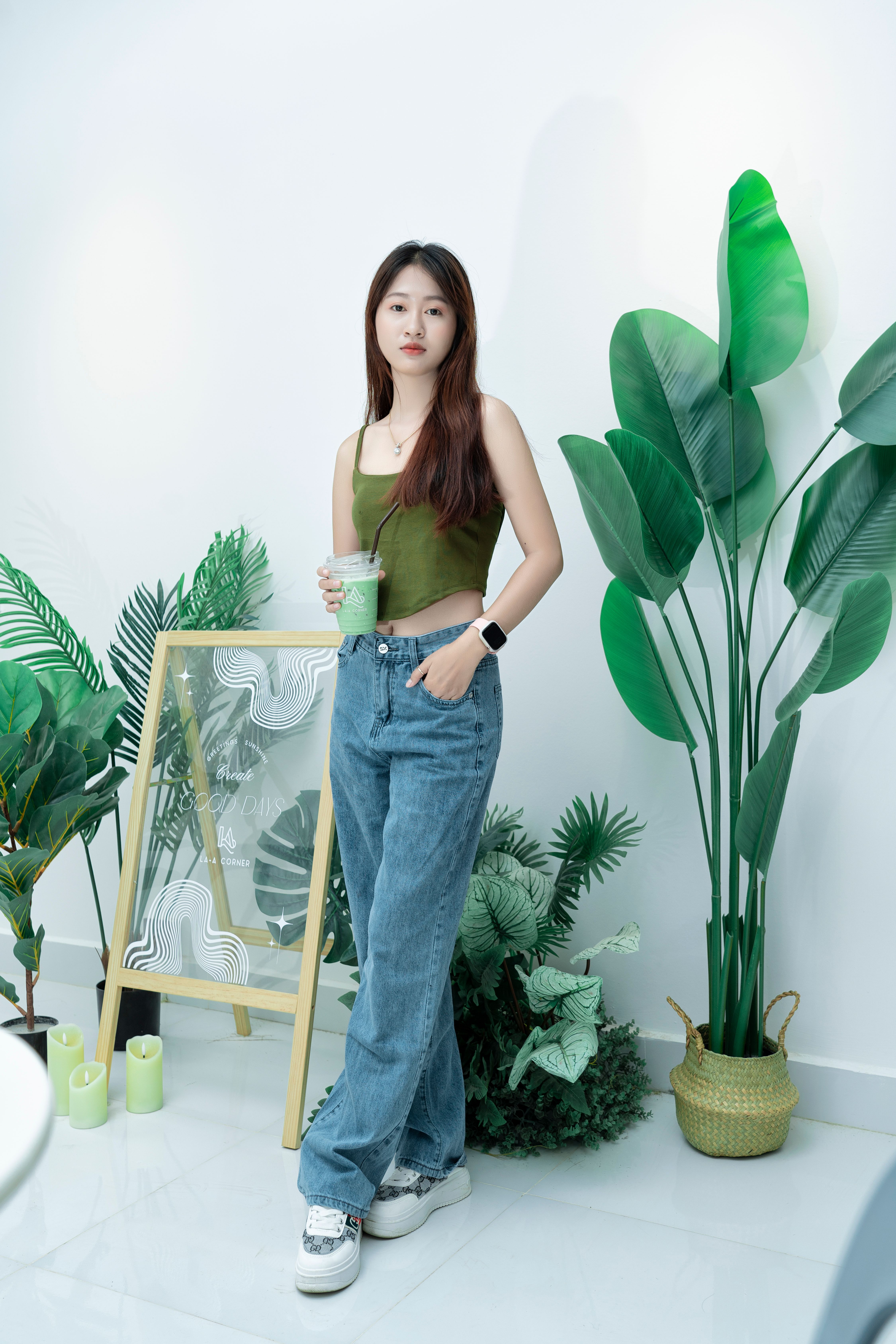 A woman standing in front of plants and a plant · Free Stock Photo