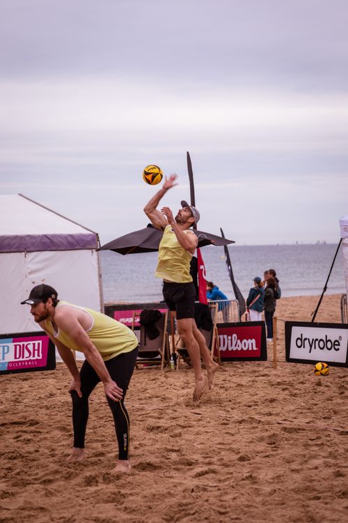 Free Exciting beach volleyball match with athletic players in Bournemouth, England. Stock Photo