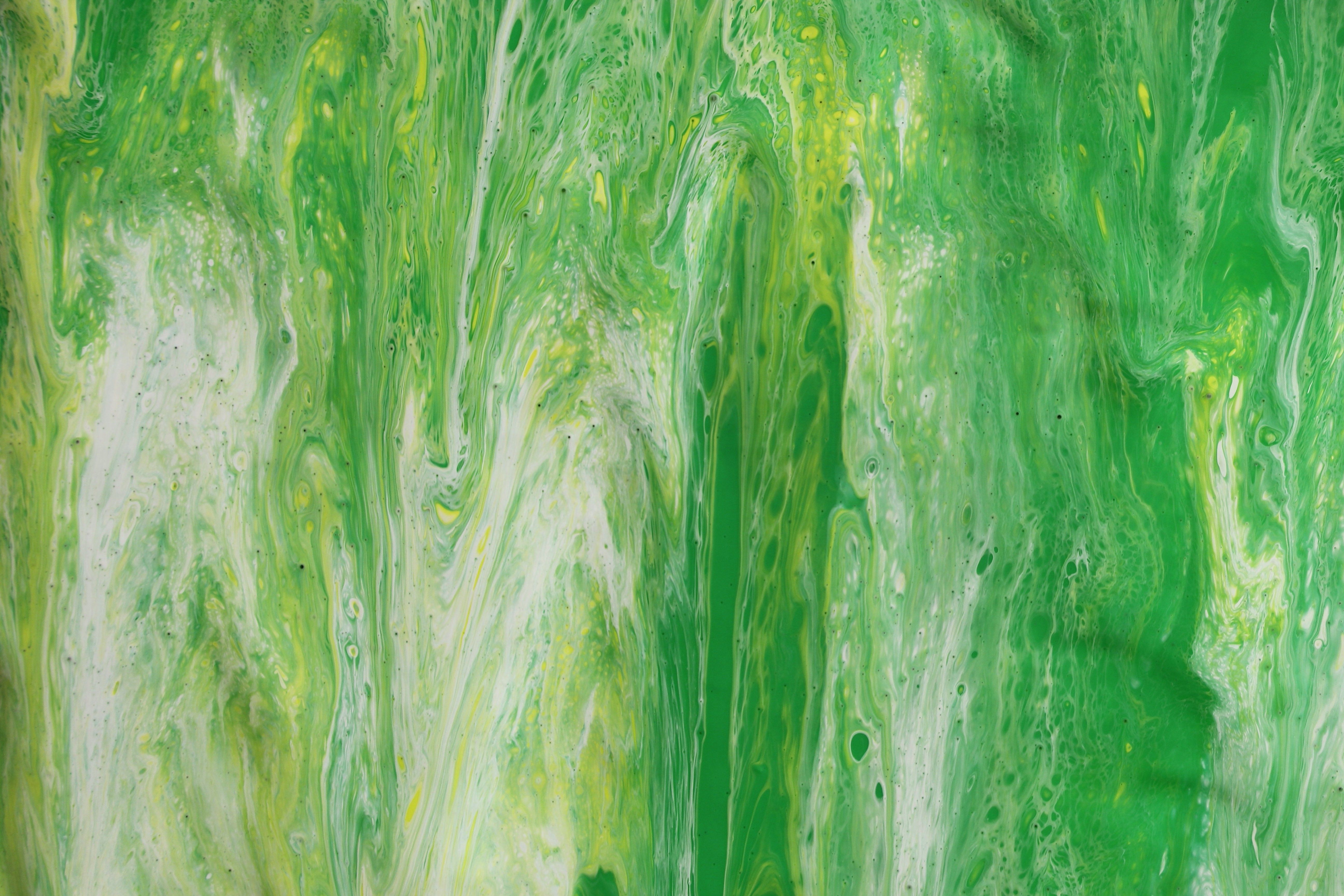 A vivid and colorful abstract acrylic painting with dynamic green patterns and flowing texture.