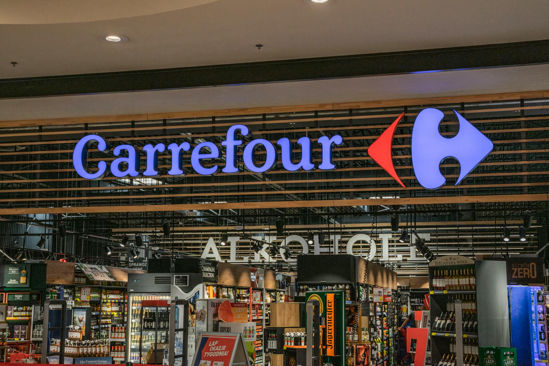 Vibrant Carrefour storefront with neon signage displaying in a retail environment.