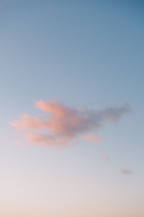 Free Gentle pink cloud in a soft blue sky during twilight, evoking a sense of peace and tranquility. Stock Photo