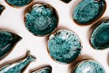 Turquoise-glazed plates drying on a bench — photo by Mathias Reding on Pexels
